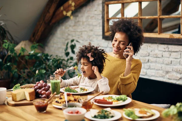 African American Little Girl Eating While Sitting Mother Lap Who — Foto de Stock