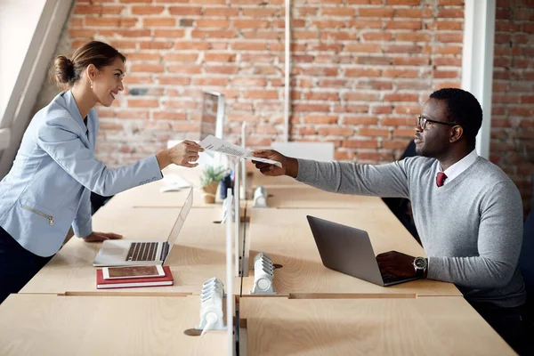 Happy Businesswoman Passing Document Her African American Colleague While Working — Foto de Stock