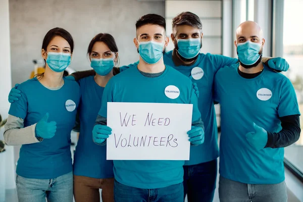 Group of volunteers with face masks inviting people to join their team and become one of them.