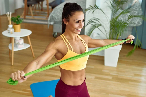 Happy Muscular Build Woman Exercising Resistance Band Home — Foto de Stock