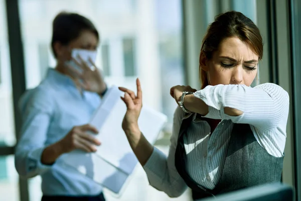 Young Businesswoman Coughing Elbow Office Her Coworker Background — 스톡 사진