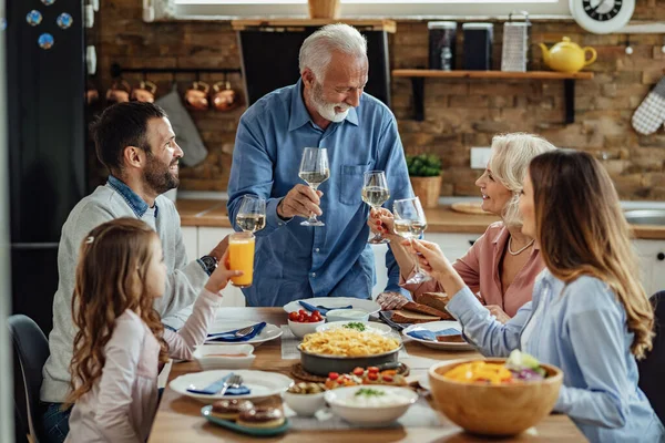 Happy Multi Generation Family Toasting While Having Lunch Together Dining — Zdjęcie stockowe