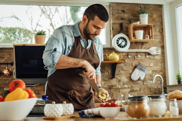 Young Man Preparing Healthy Food Peeling Avocado Kitchen — 스톡 사진