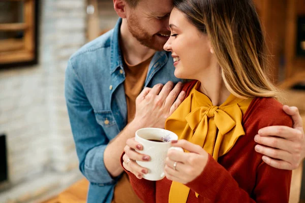Young Smiling Couple Enjoying Love While Having Cup Coffee Home — Stockfoto