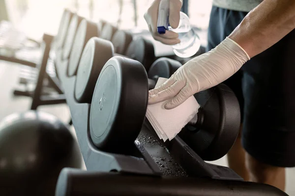 Close Athlete Wearing Protective Gloves Disinfecting Hand Weights Health Club — Φωτογραφία Αρχείου