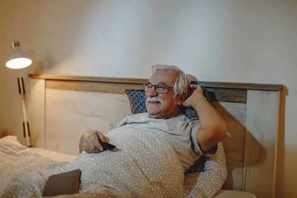 Happy Mature Man Enjoying While Watching Bed Night — Stockfoto