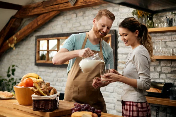 Young Happy Couple Preparing Breakfast Kitchen Man Pouring Milk Girlfriend — ストック写真