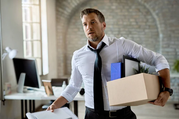 Fired Businessman Leaving Office Carrying His Belongings — Stockfoto