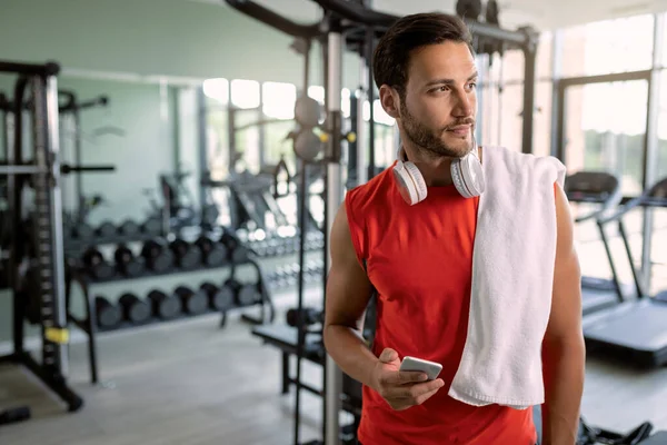 Young Sportsman Texting Cell Phone Looking Away Health Club — Stockfoto