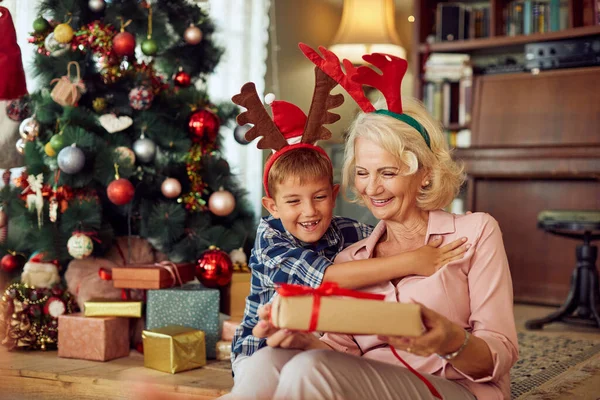 Happy Senior Woman Surprising Her Grandson Present Christmas Day Home — ストック写真