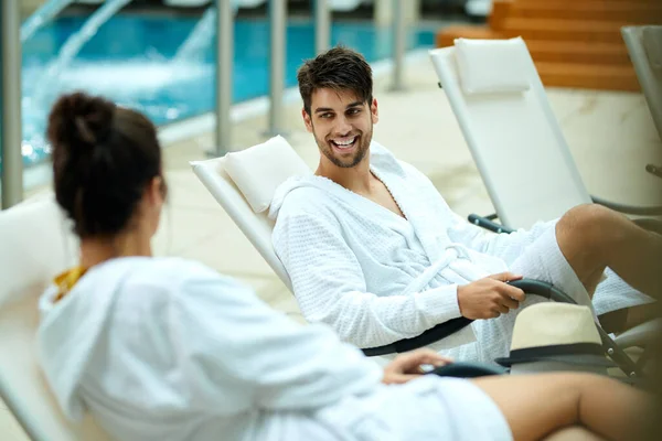 Young Couple Bathrobes Talking While Sitting Pool Spending Weekend Spa — Stock Photo, Image