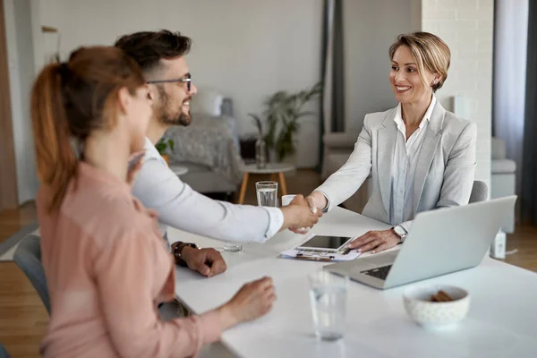 Happy Real Estate Agent Greeting Couple While Having Meeting Office — Foto Stock