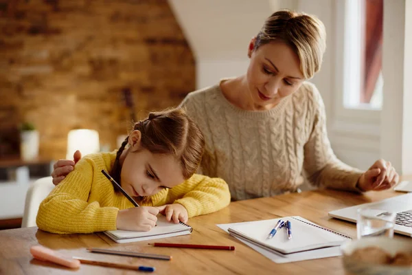 Small Girl Homeschooling Writing Notebook While Mother Assisting Her — Foto de Stock