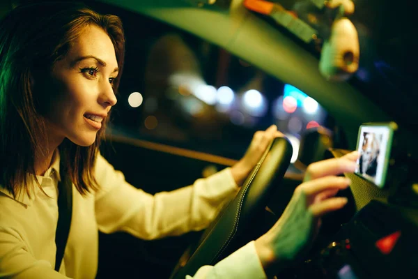 Young Woman Driving Car Night Looking Direction Map While Using — Stockfoto