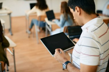IT professor using touchpad during a class at high school classroom. 