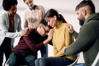 Toplum merkezindeki bir toplantıda stres atma etkinlikleri sırasında birbirlerine destek olan bir grup insan.. 