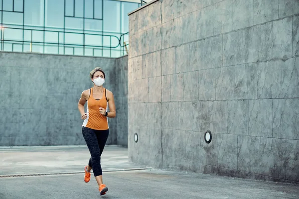 sportswoman with face mask exercising outdoors.