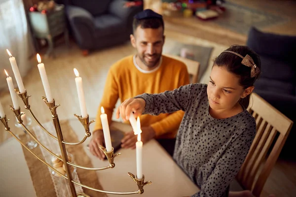 Small Jewish Girl Lightning Traditional Candles Menorah While Celebrating Hanukkah — Fotografia de Stock