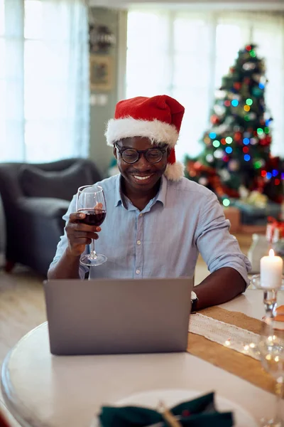 Happy African American Man Using Laptop While Toasting Wine Video — ストック写真