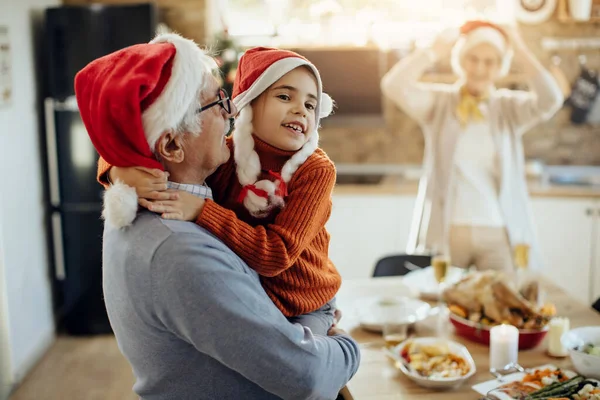 Happy Grandfather Holding His Granddaughter While Celebrating Christmas Together Home — Foto Stock