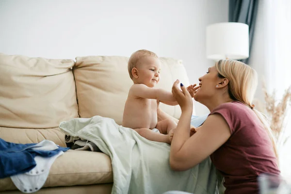 Happy Mother Dressing Her Baby Son Having Fun His Home — Foto de Stock