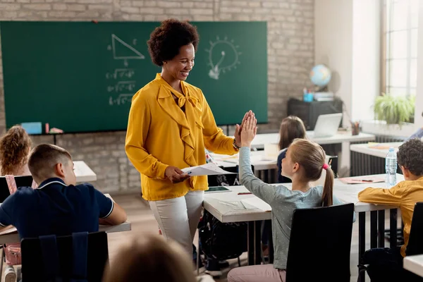 Happy African American Teacher Giving High Five Elementary Student While — Foto de Stock