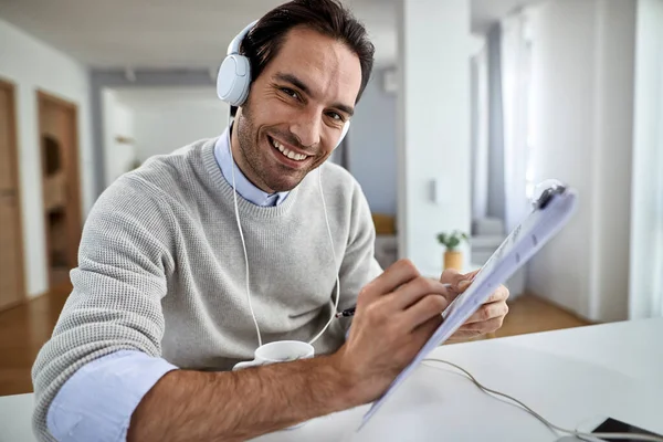 Happy Businessman Headphones Working Paperwork Home Looking Camera — Zdjęcie stockowe