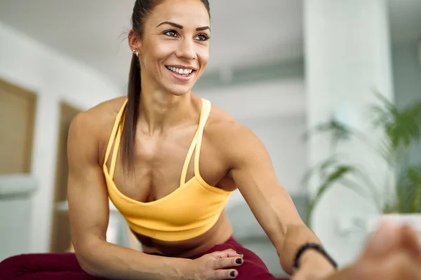 Young Happy Athletic Woman Doing Stretching Exercises While Working Out — стоковое фото