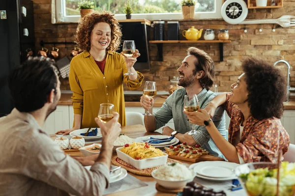 Happy Woman Holding Toast While Enjoying Lunch Her Friends Home — Foto de Stock