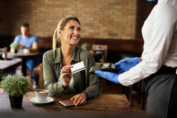 Young Happy Woman Using Contactless Credit Card While Paying Waitress Stok Gambar Bebas Royalti