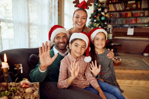 Happy Family Waving Camera While Celebrating Christmas Home — ストック写真