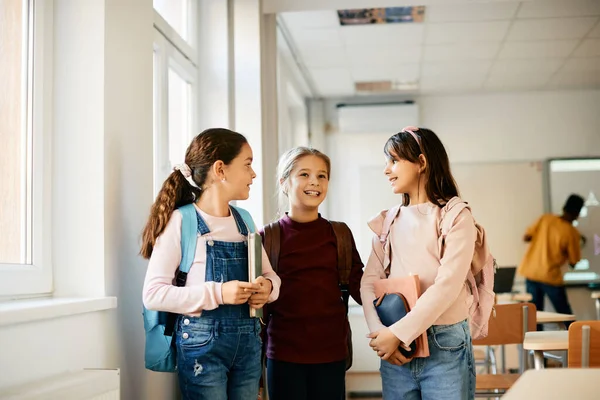 Happy Little Girls Talking Each Other While Standing Classroom Elementary — Foto de Stock