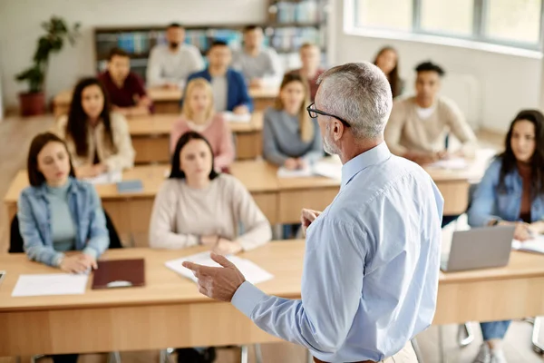 Back View Mature Professor Giving Lecture Large Group College Students — Stockfoto