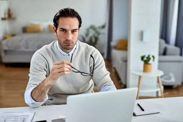 Young Entrepreneur Using Computer While Working Home Looking Camera — Stockfoto