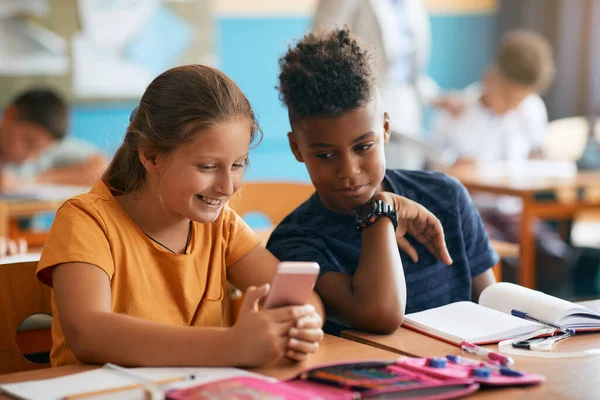 Happy Elementary Students Using Smart Phone Class School — Stockfoto