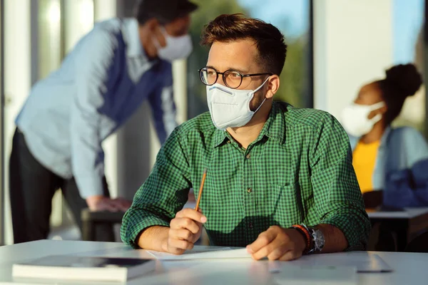 Pensive University Student Wearing Protective Face Mask While Writing Exam — Foto Stock