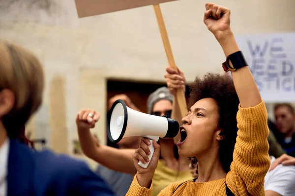 Young African American Woman Raised Fist Shouting Megaphone While Being — Stock Fotó