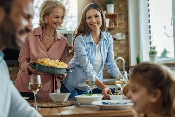 Happy Women Serving Food While Preparing Dining Table Family Lunch — Foto Stock