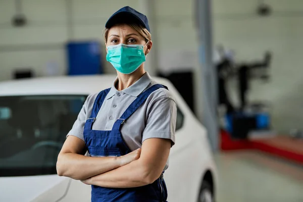 Female Auto Mechanic Wearing Protective Face Mask While Standing Arms — ストック写真