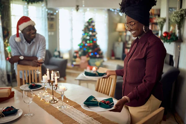 Happy African American Woman Decorating Dining Table Her Husband While — ストック写真