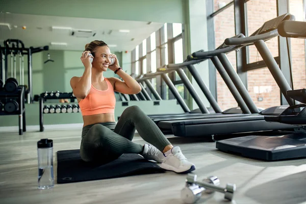 Happy Sportswoman Relaxing Floor Listening Music Headphones Health Club — Fotografia de Stock