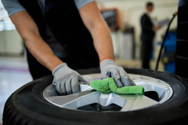Close Auto Mechanic Cleaning Car Tire While Working Auto Repair Foto Stock