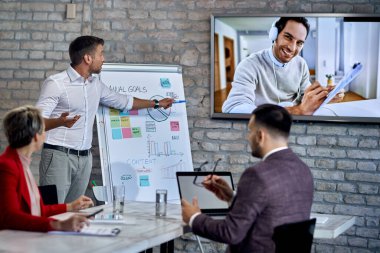 Business team having video conference during a presentation in the office. 