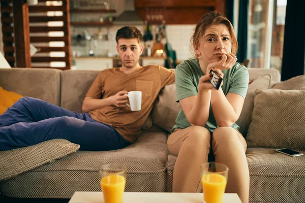 Young Couple Relaxing Watching Home Focus Woman Feeling Bored While — 스톡 사진