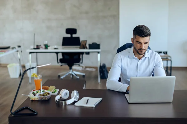 Young Businessman Using Computer While Working Office — Photo