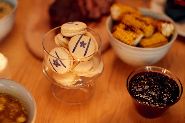 Close-up of Jewish cookies with star of David during meal on Hanukkah.