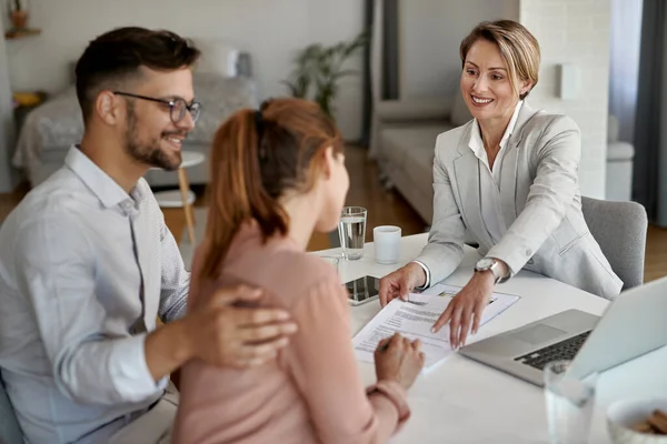 Happy Real Estate Agent Having Meeting Young Couple Pointing Place — Foto Stock