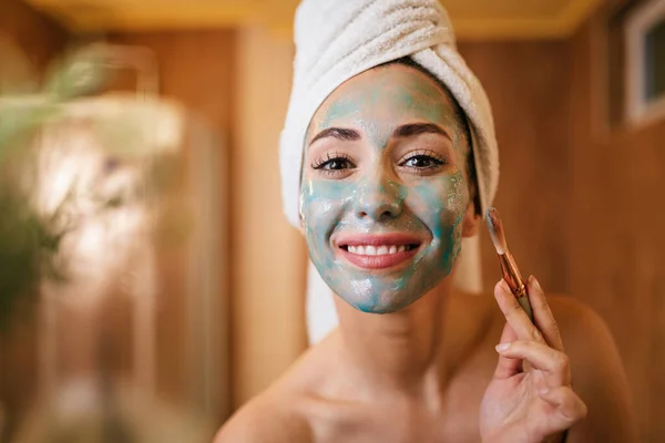 Young Smiling Woman Applying Facial Mask Brush Bathroom — Φωτογραφία Αρχείου