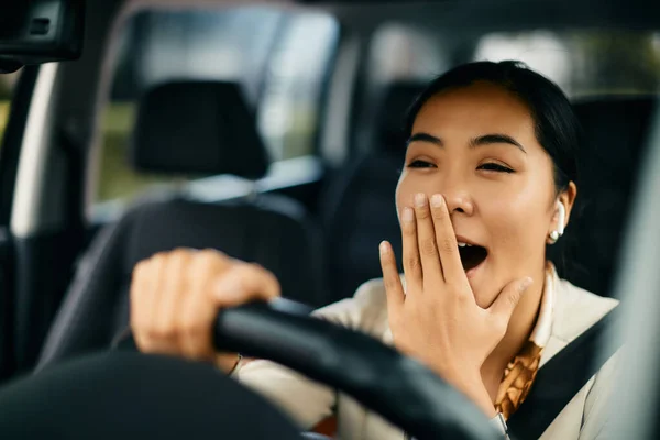 Young Exhausted Asian Woman Driving Car Yawning Steering Wheel — 图库照片