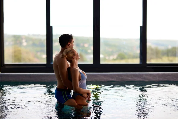 Smiling Couple Embracing While Standing Thermal Pool Enjoying View Window — Stok fotoğraf